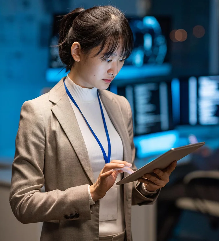 Analyst reviewing operating data on a tablet